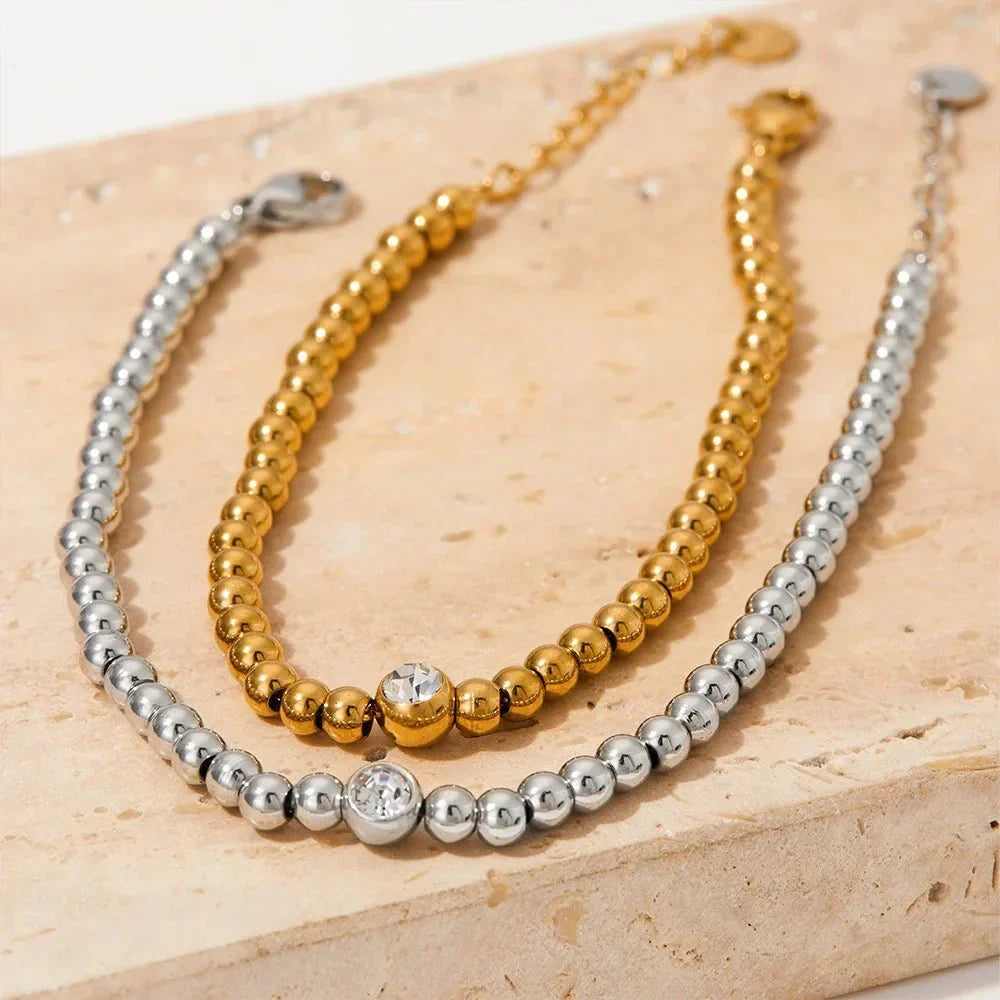 Collana e bracciale con perline e diamante centrale 18k
