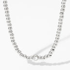Collana e bracciale con perline e diamante centrale 18k