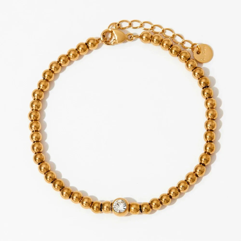 Collana e bracciale con perline e diamante centrale 18k