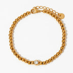 Collana e bracciale con perline e diamante centrale 18k