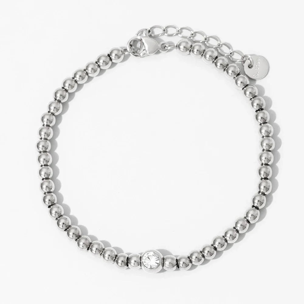 Collana e bracciale con perline e diamante centrale 18k