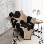 Coperta decorativa in tessuto morbido con motivo geometrico