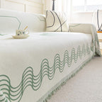 Copridivano a onde curve con frange decorative