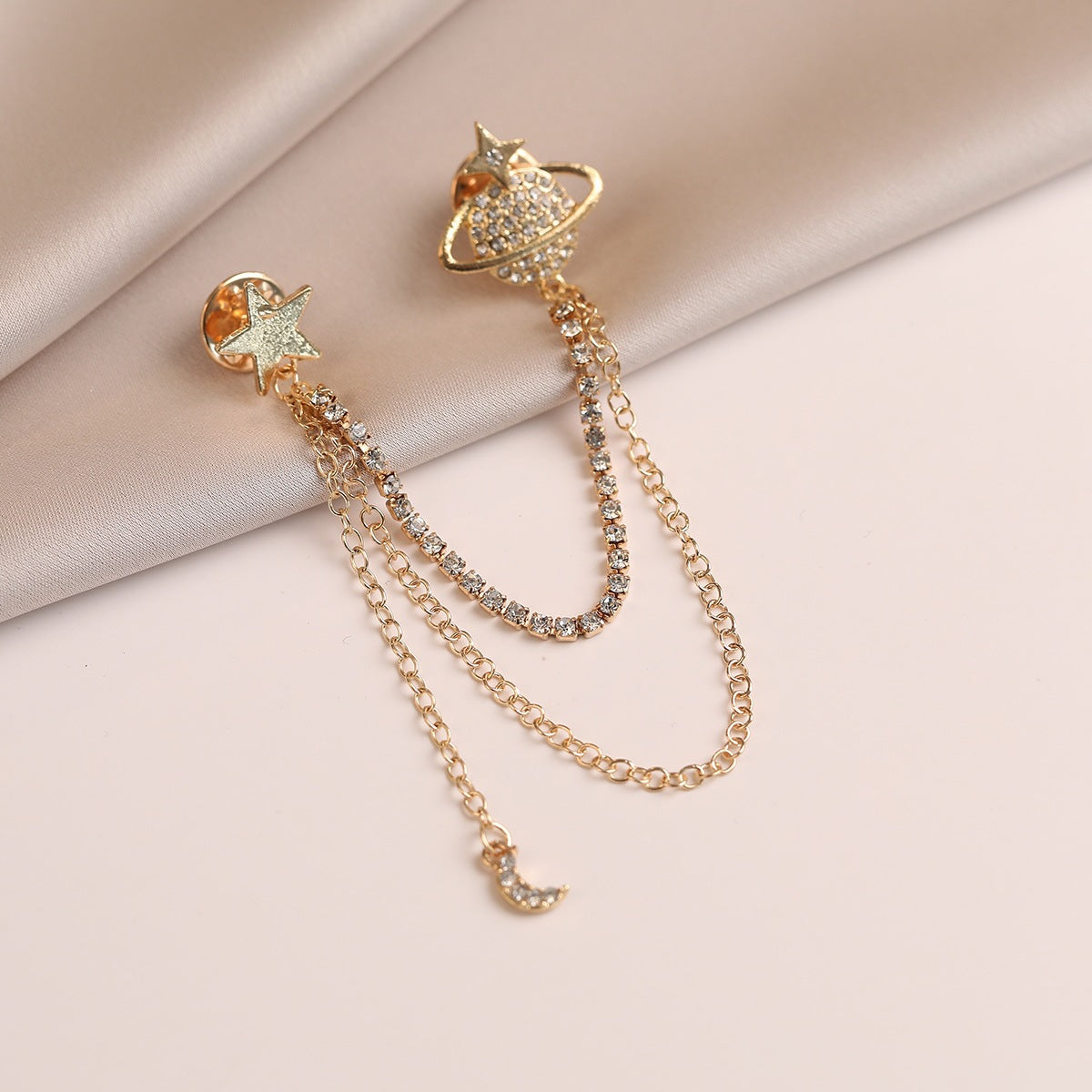 Orecchini con stella e pianeta