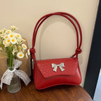 Pochette con fiocco e manico