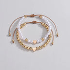 Set 2 bracciali con perline bianche e oro e ciondolo cuore