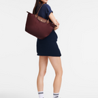 Dettaglio manici in pelle della borsa Longchanp Le Pliage