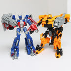 Bambino che gioca con le action figure Transformer Optimus e Bumblebee